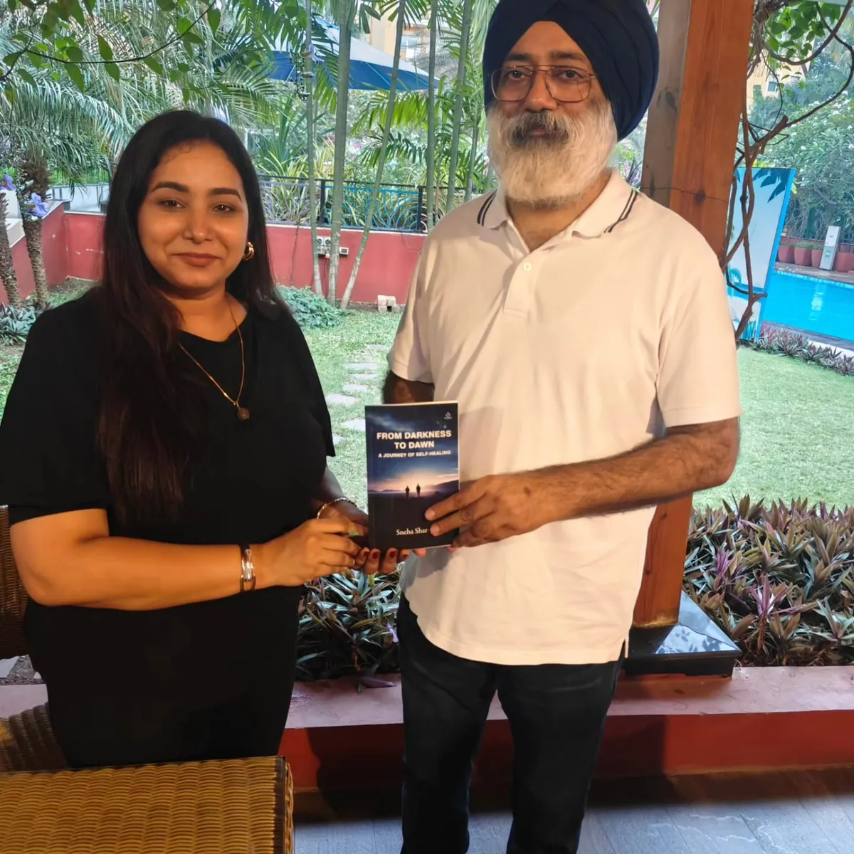 Sneha presenting her book From Darkness to Dawn